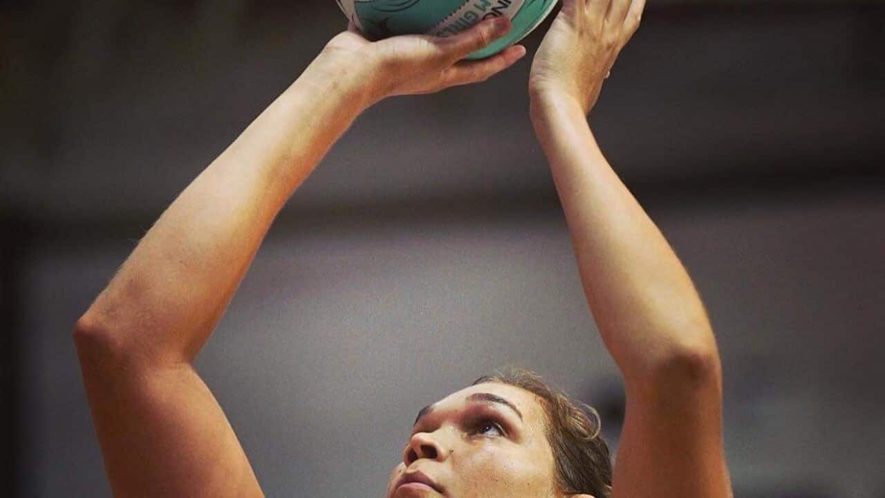 Donnell shooting netball at goal