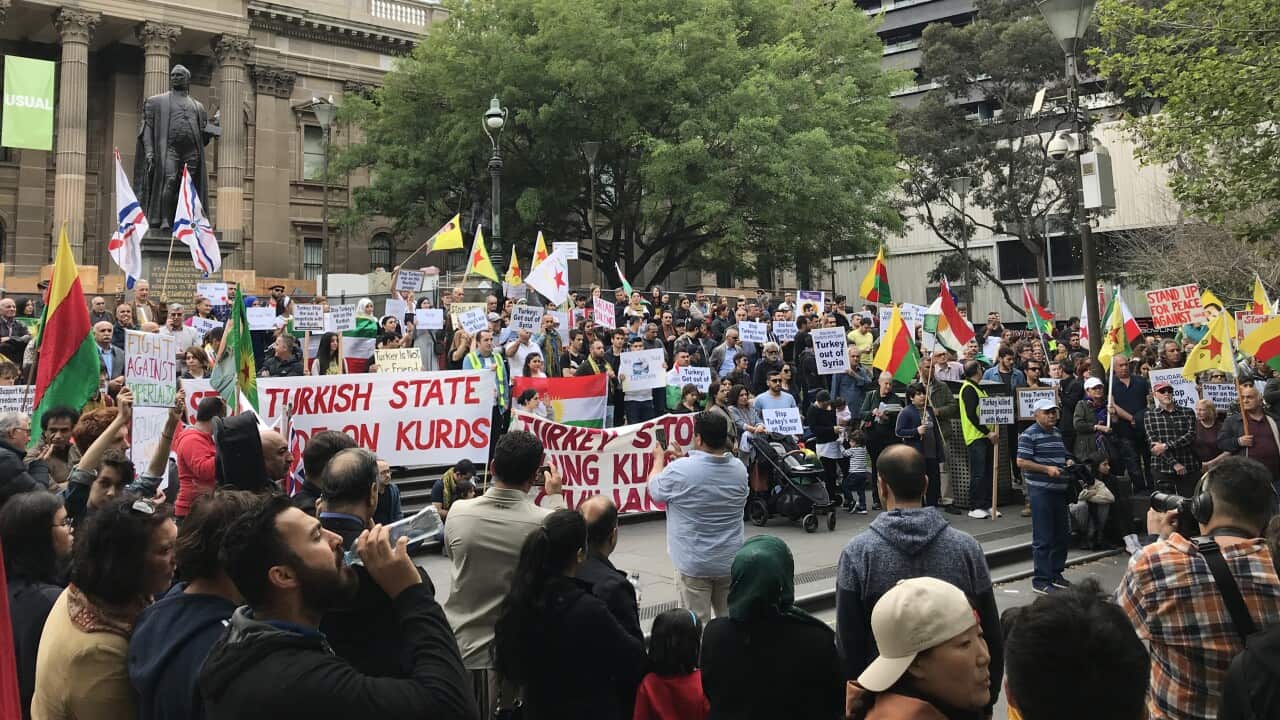 Demonstrators rally to show solidarity with Kurds affected by Turkey's incursion into northern Syria, at the State Library of Victoria in Melbourne, Saturday, October 12, 2019. (AAP Image/Caroline Schelle) NO ARCHIVING