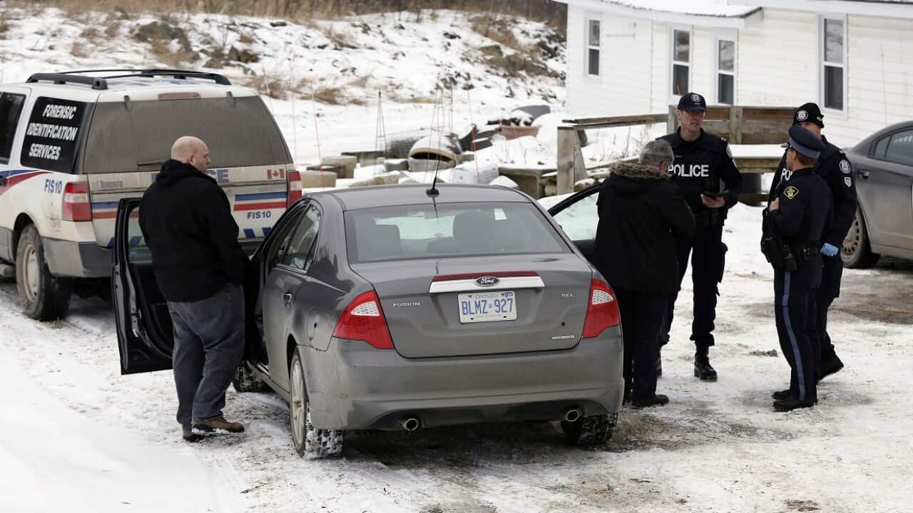 Toronto police forensic officers stand outside a house in Madoc, Ont. on Friday, January 19, 2018. 