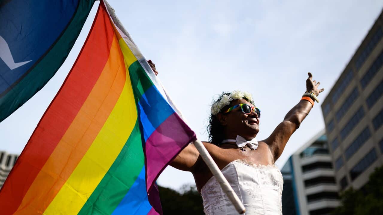 A participant waves a flag ahead of the 42nd annual Gay and Lesbian Mardi Gras parade in Sydney, Saturday, February 29, 2020. (AAP Image/James Gourley) NO ARCHIVING