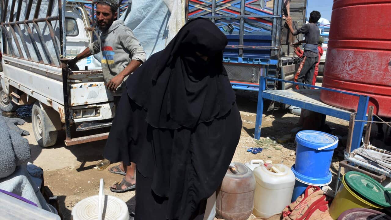 The wife of an Islamic state fighter prepares to leave a camp (AAP).jpg