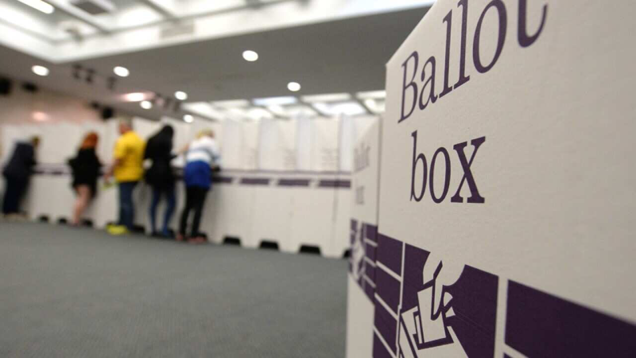 People cast their vote at a voting centre