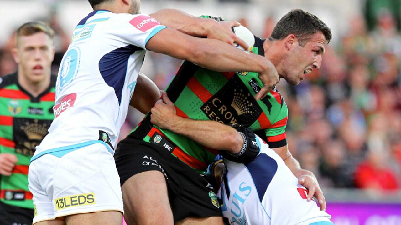 South Sydney's Sam Burgess is tackled by Titans players