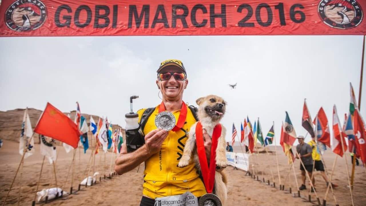 eonard of Australia holds the stray do
