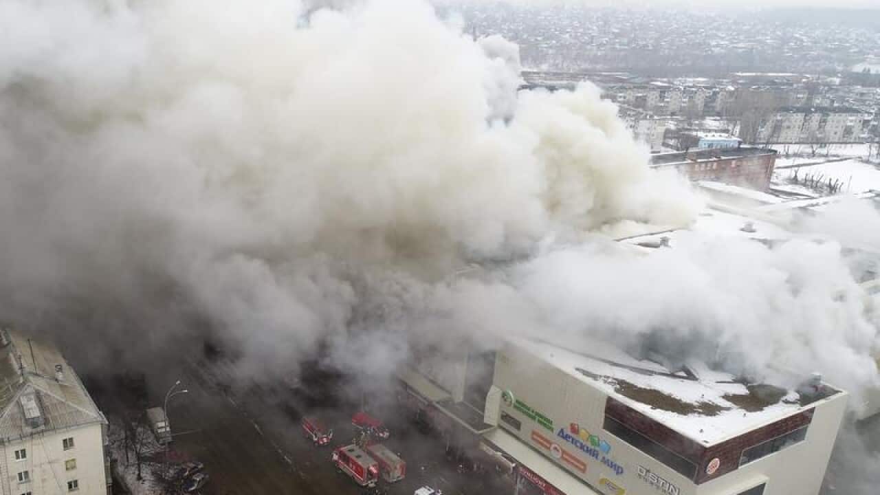 Smoke billows from the shopping centre in Kemerovo