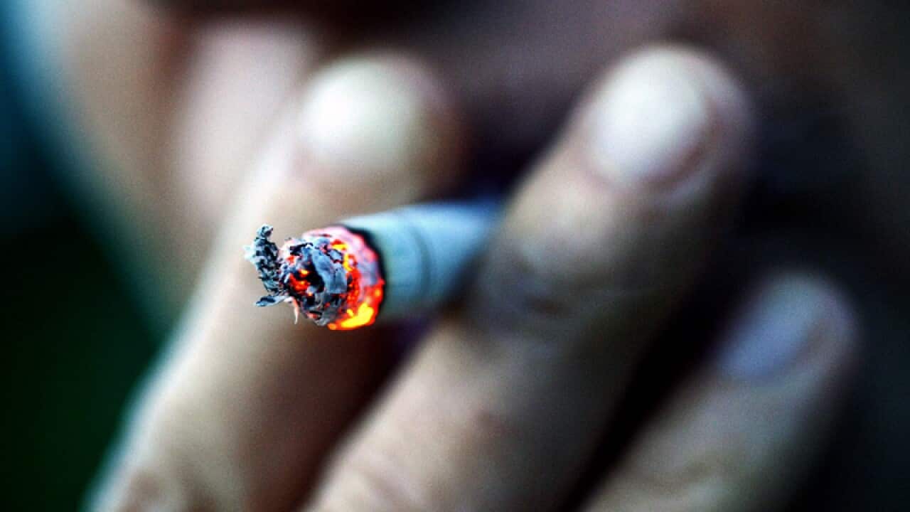 A woman smokes a cigarette