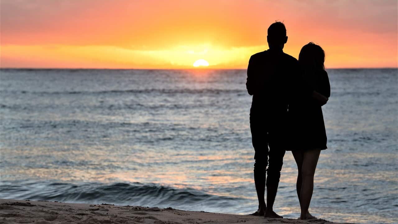 Revellers watch the sunrise on New Years Day at Bondi Beach in Sydney, Saturday, January 1, 2022.