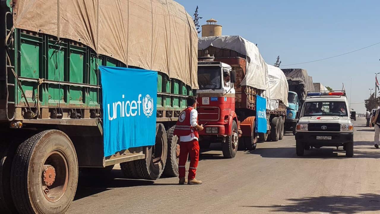 A handout picture made available on the website of Syrian Red Crescent showing an aid convoy preparing to set off to deliver aid to the western side of Aleppo