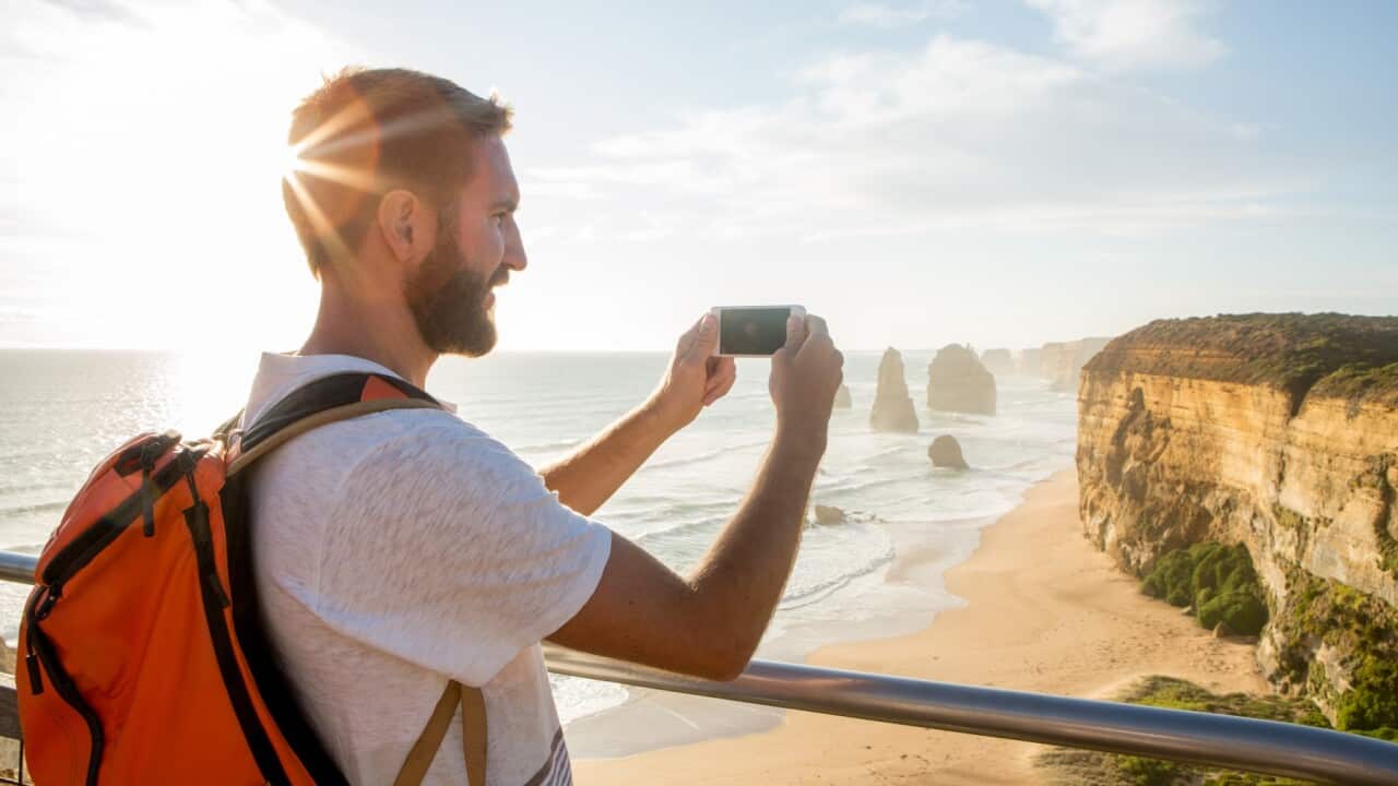 Tourist photographing the 12 Apostles