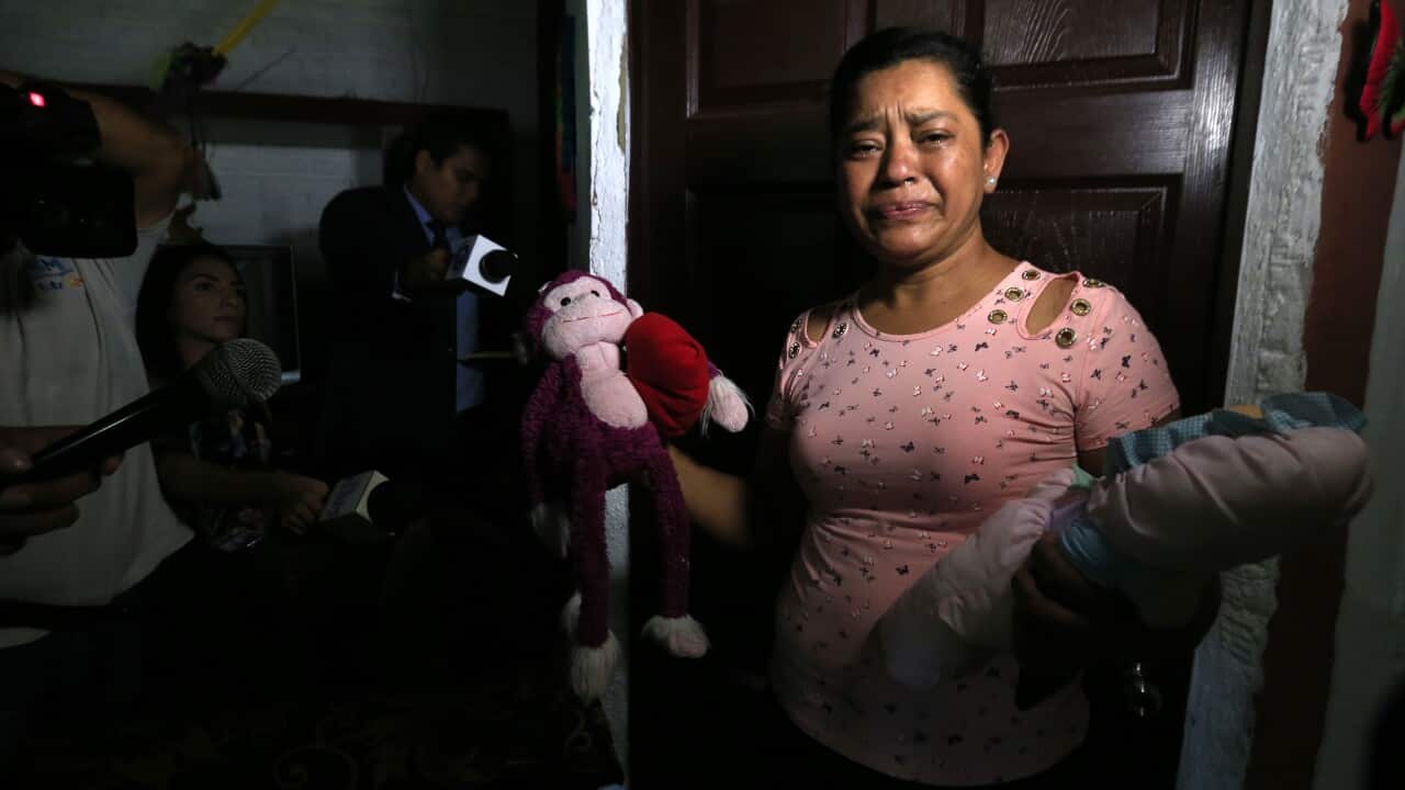 Rosa Ramirez sobs as she shows journalists toys that belonged to her nearly 2-year-old granddaughter Valeria