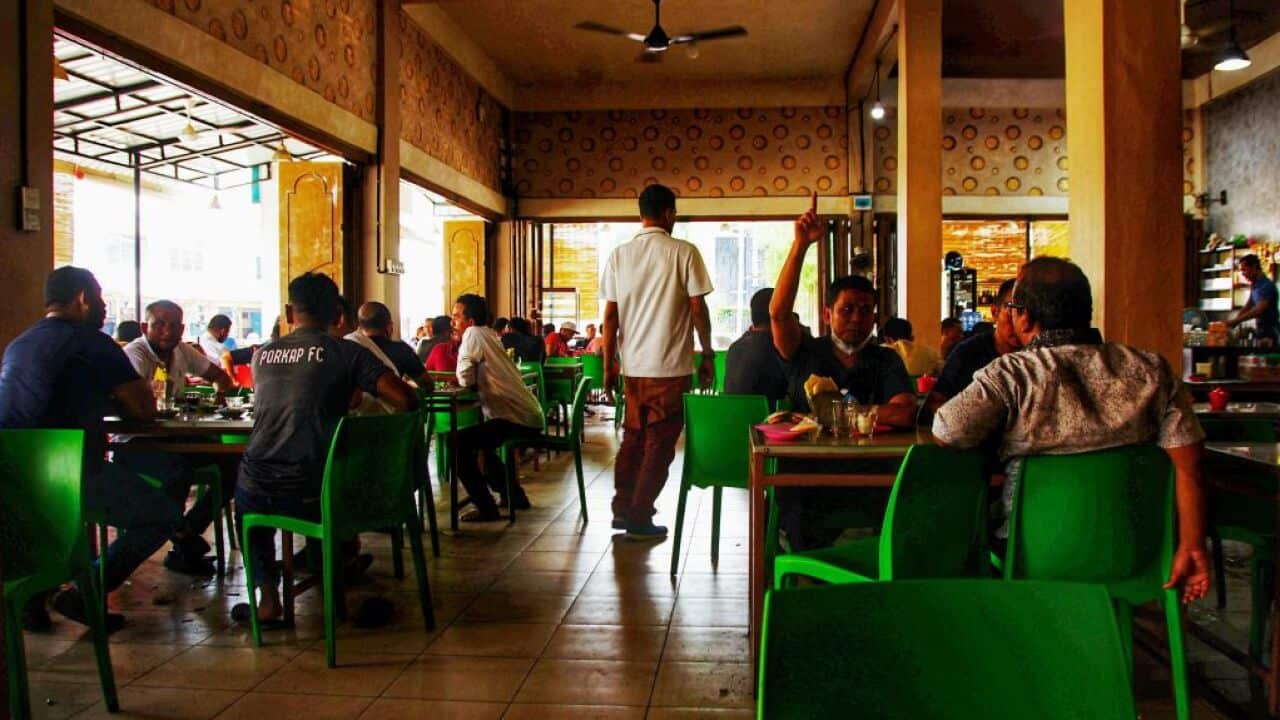 Customers dine at a restaurant in Lhokseumawe, Aceh, as small shops, street-side restaurants and some shopping malls reopened in coronavirus-battered Indonesia.