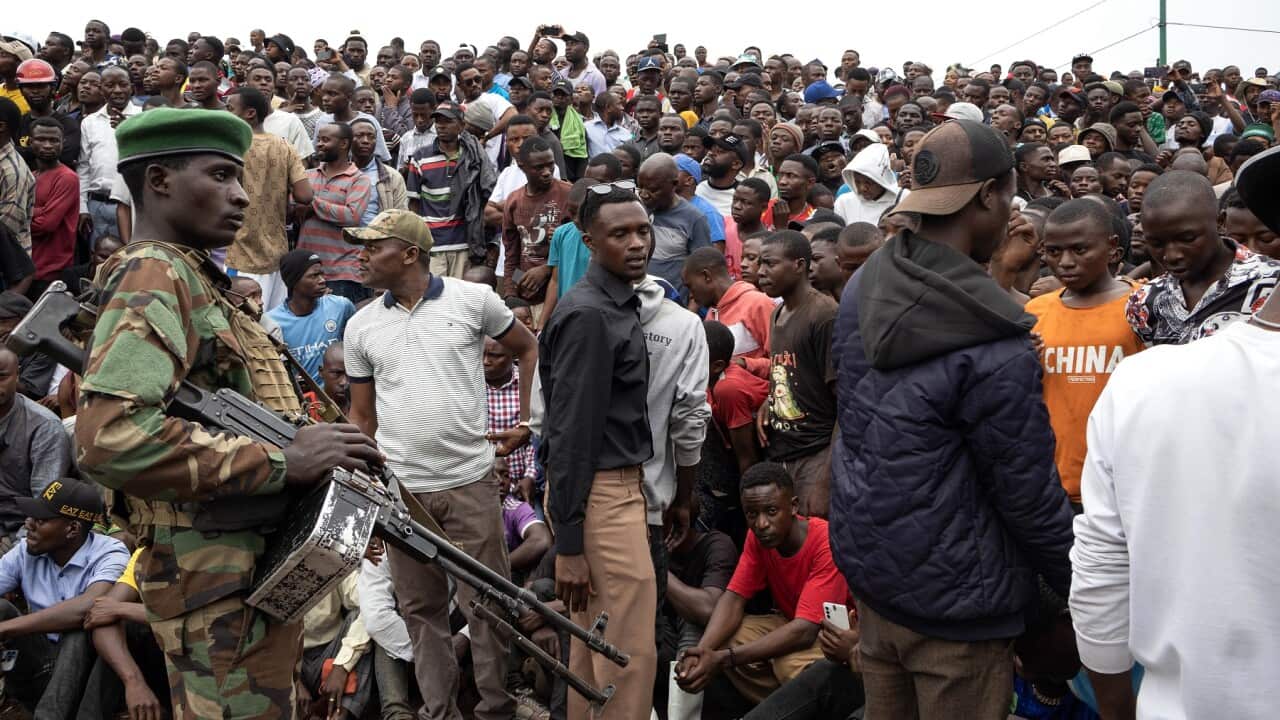 City residents gather to attend a meeting called by the M23 rebel group in Goma.