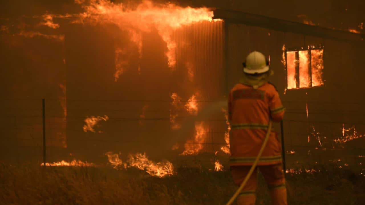 NSW Rural Fire Service crews fight the Gospers Mountain Fire as it impacts a property at Bilpin, Saturday, 21 December, 2019.