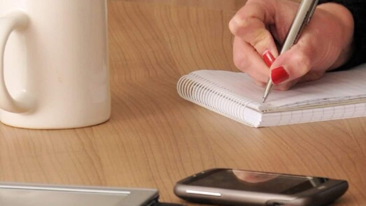 people making notes during a meeting