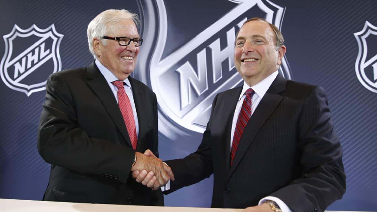 NHL Commissioner Gary Bettman (R) and businessman Bill Foley