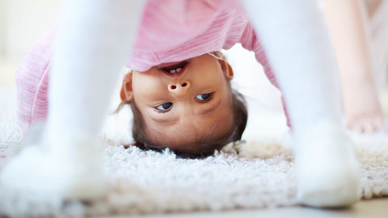 Active little girl somersaulting