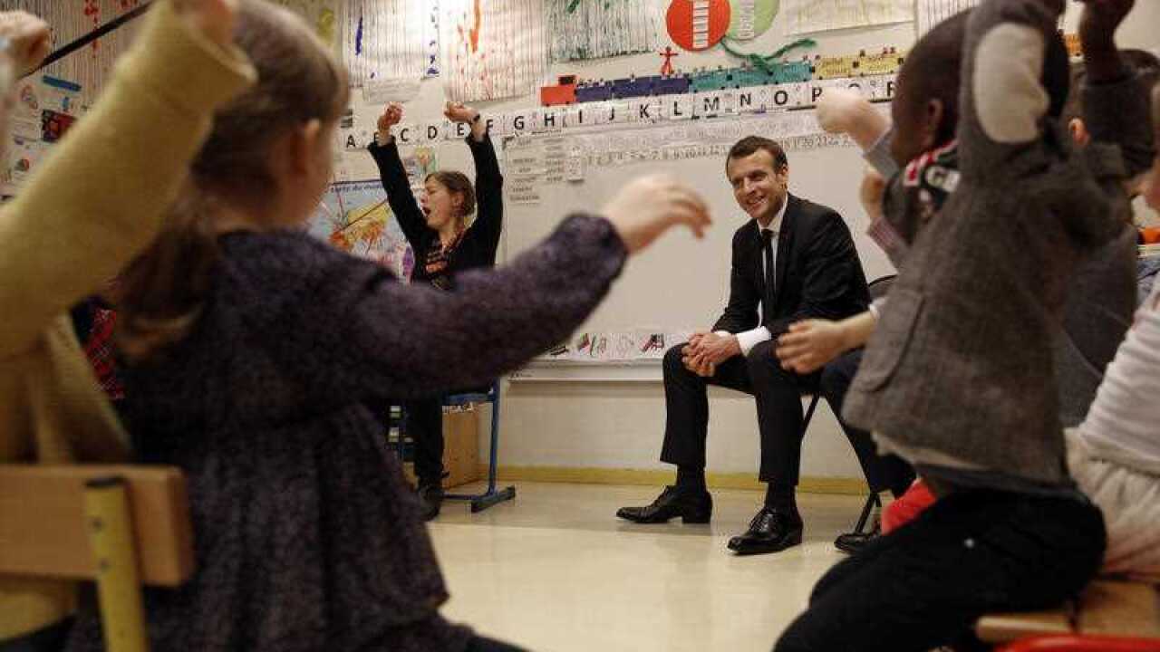 French President Emmanuel Macron and French Education Minister Jean-Michel Blanquer speak during a visit at the Emelie pre-school in Paris, France on Tuesday, March 27, 2018.