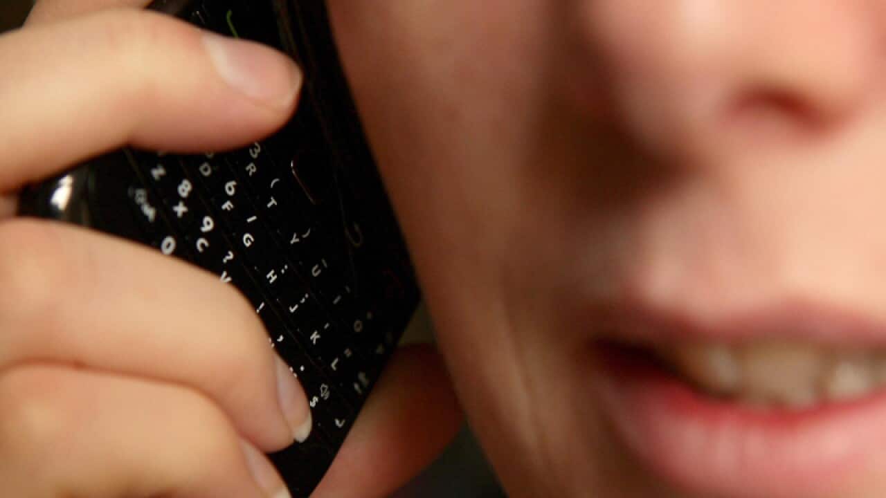 A woman talking on a mobile phone.