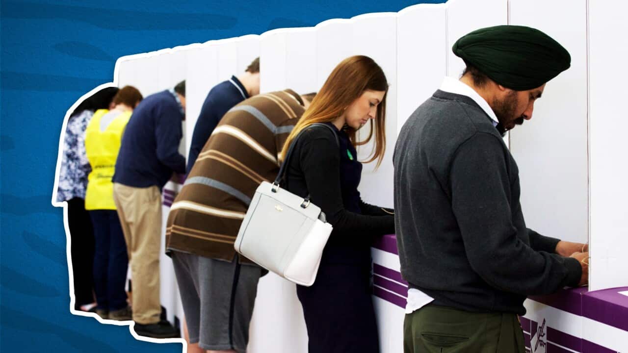Voters in a polling booth (SBS).jpg