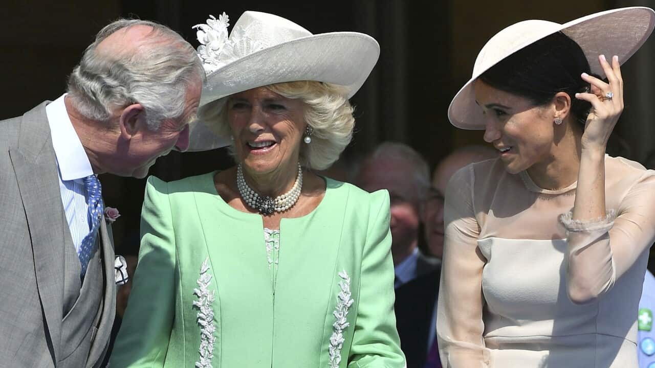 An older man sits with two women.