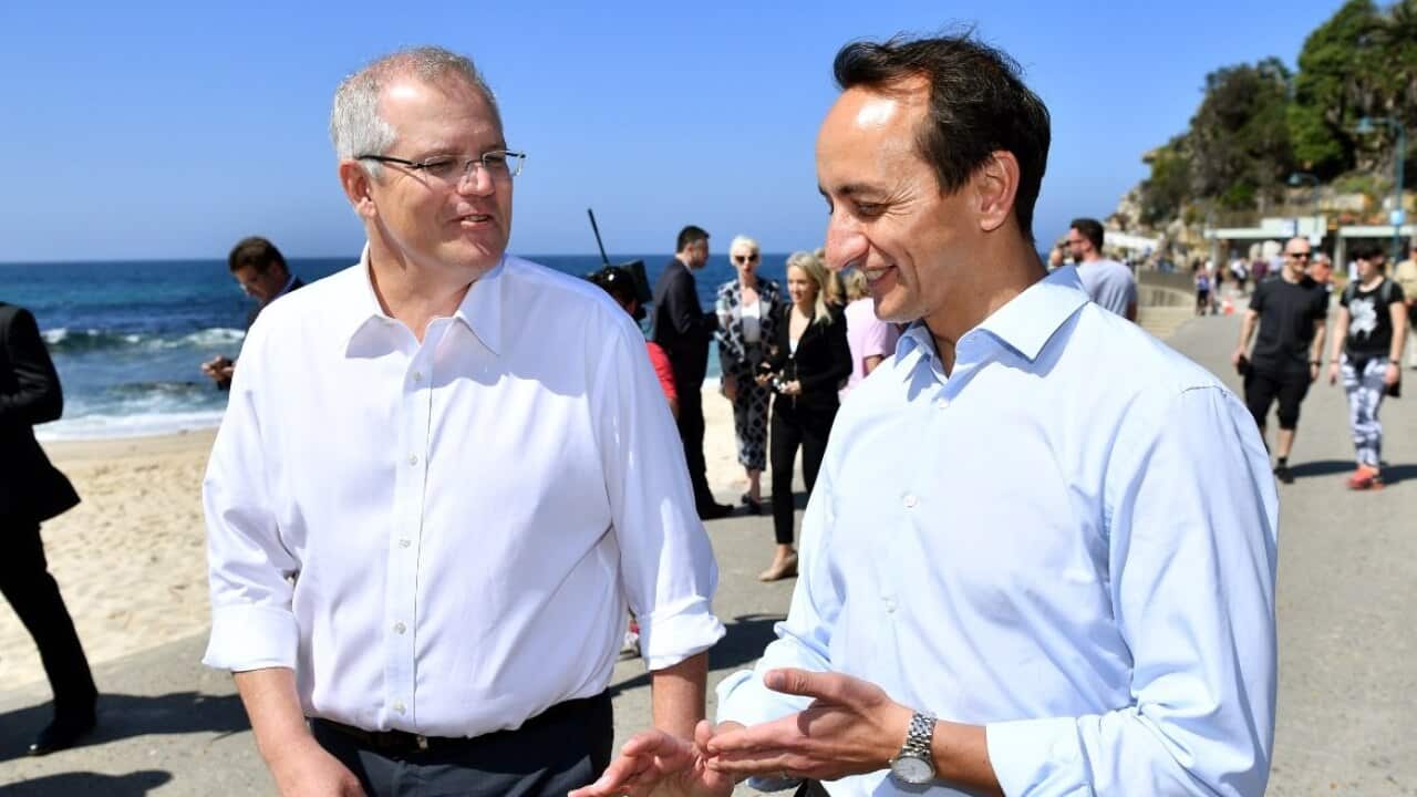 Prime Minister Scott Morrison (left) and Liberal Party candidate for Wentworth Dave Sharma speak to the media during a visit Bronte Beach in Sydney