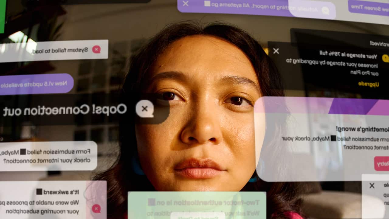 POV of laptop screen and woman with long black hair looking at multiple notifications