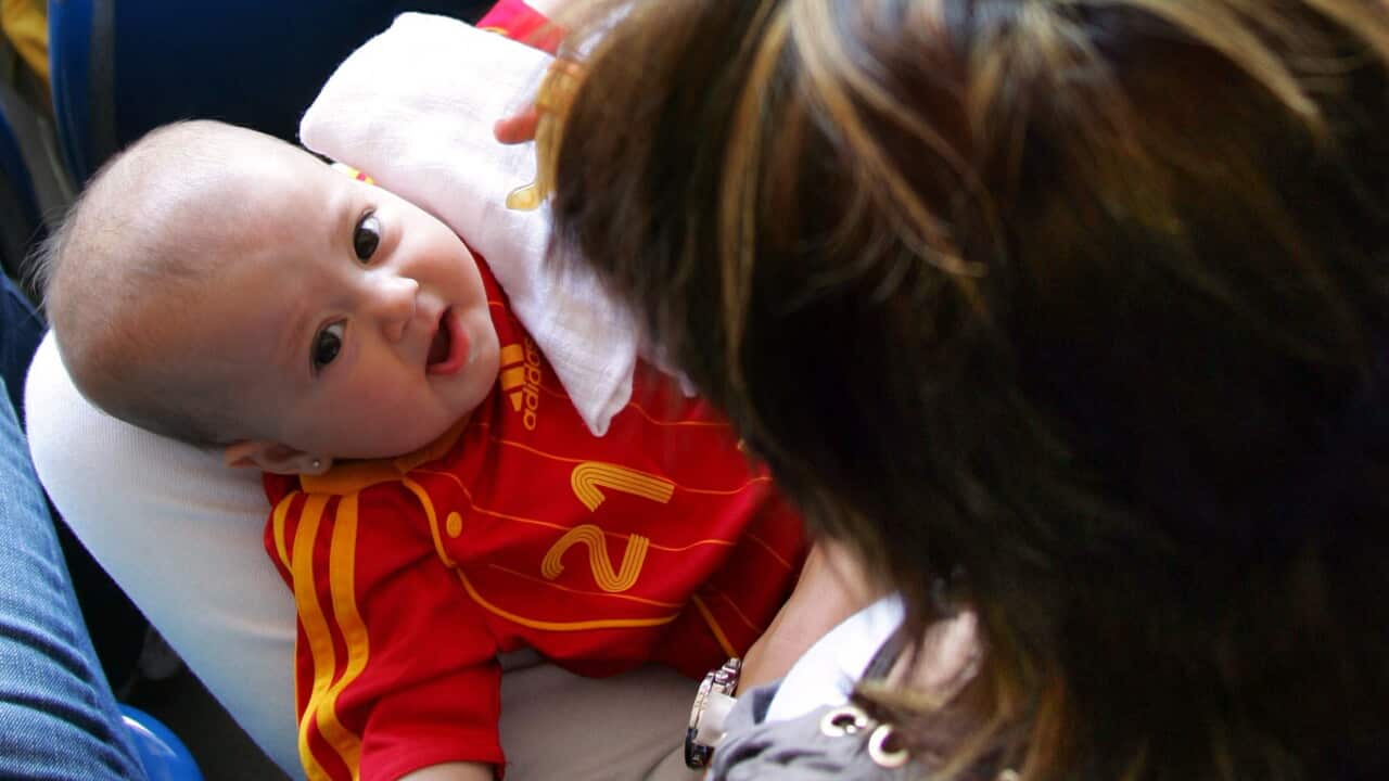 A Spanish baby wearing a Spain national football team jersey
