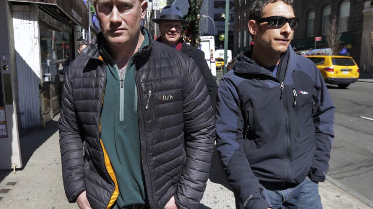 James Brady (L) and Andrew Rossig surrender to police in New York