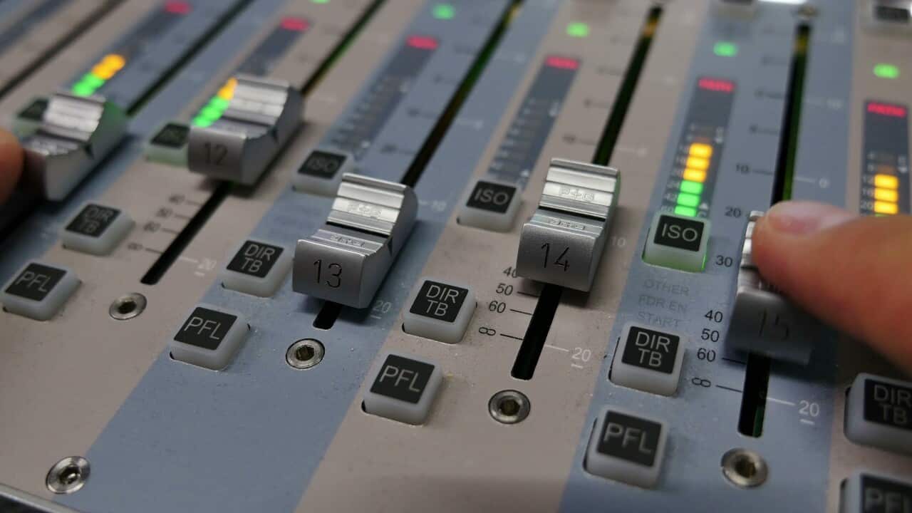 close-up-shot-of-a-person-adjusting-the-volume-on-an-audio-mixer-SBI-351561892.jpg