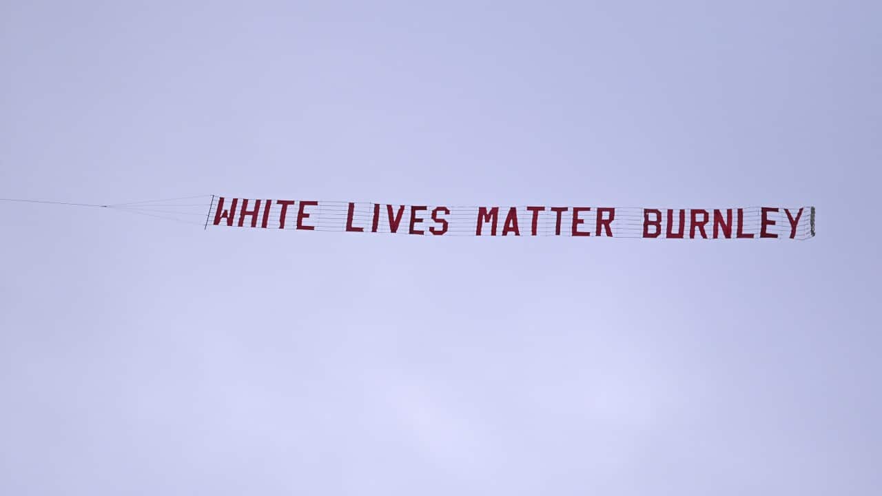 A plane towing a banner reading White Lives Matter Burnley flies above the stadium during the during the soccer match between Manchester City and Burnley.