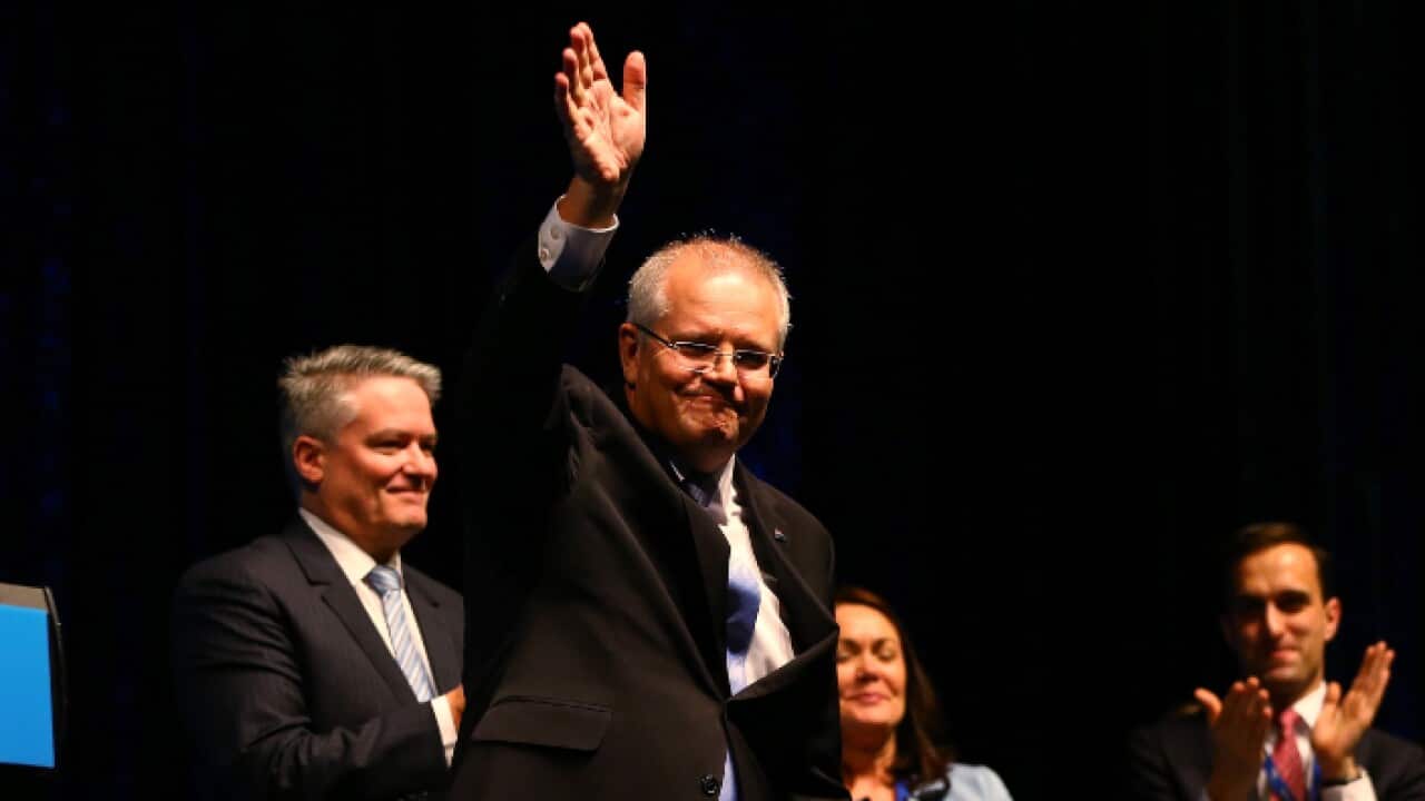 Prime Minister Scott Morrison waves during the WA State Liberal Party Conference at Crown in Perth