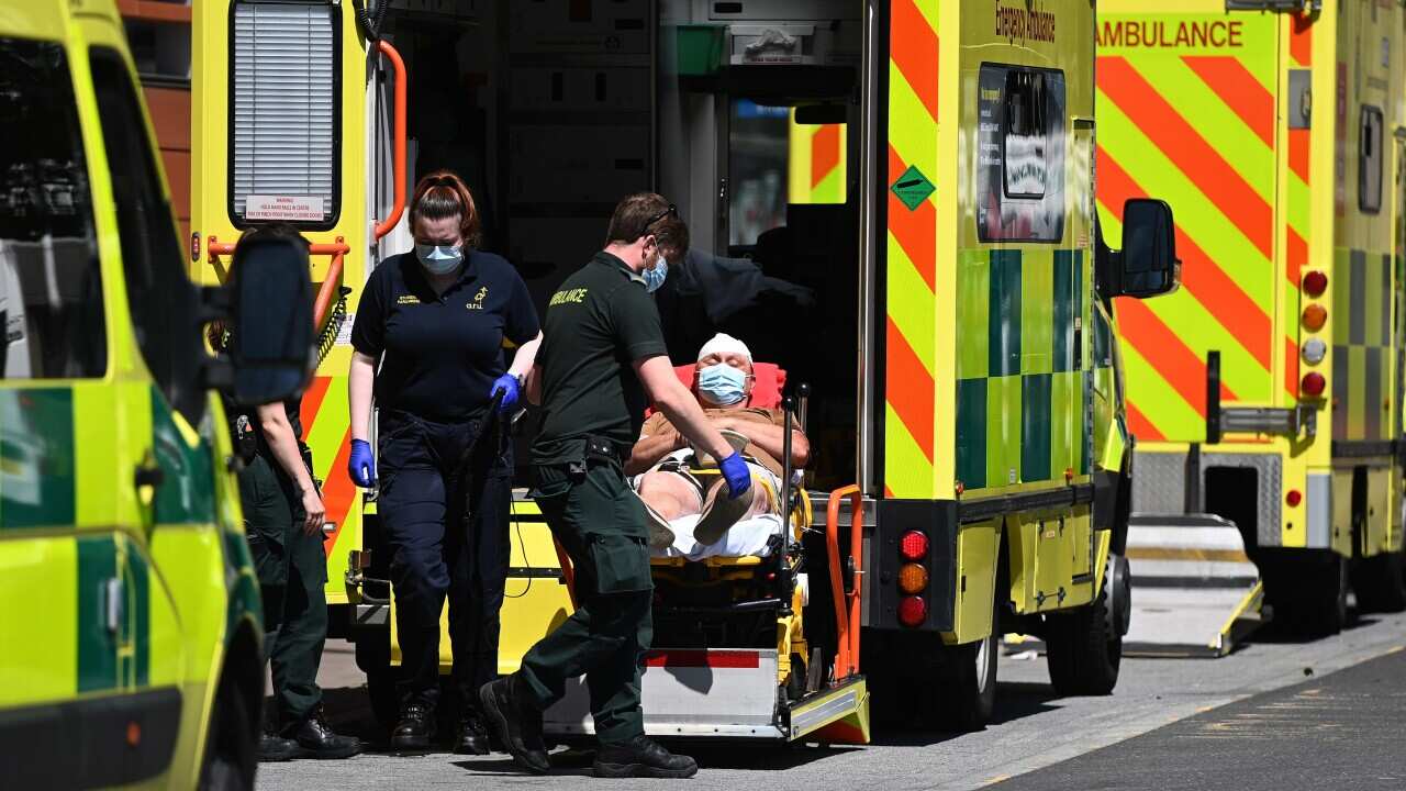 A COVID-19 patient is brought into the Royal London hospital in London, Britain, 14 June 2021.