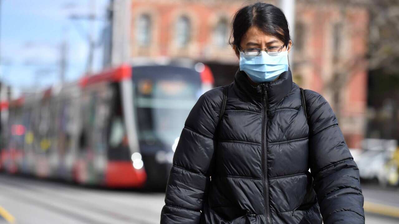 A pedestrian wearing a face mask in Sydney