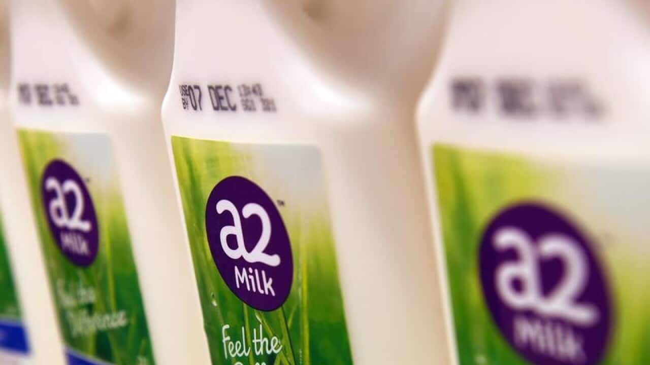 Bottles of A2 milk are displayed in a fridge
