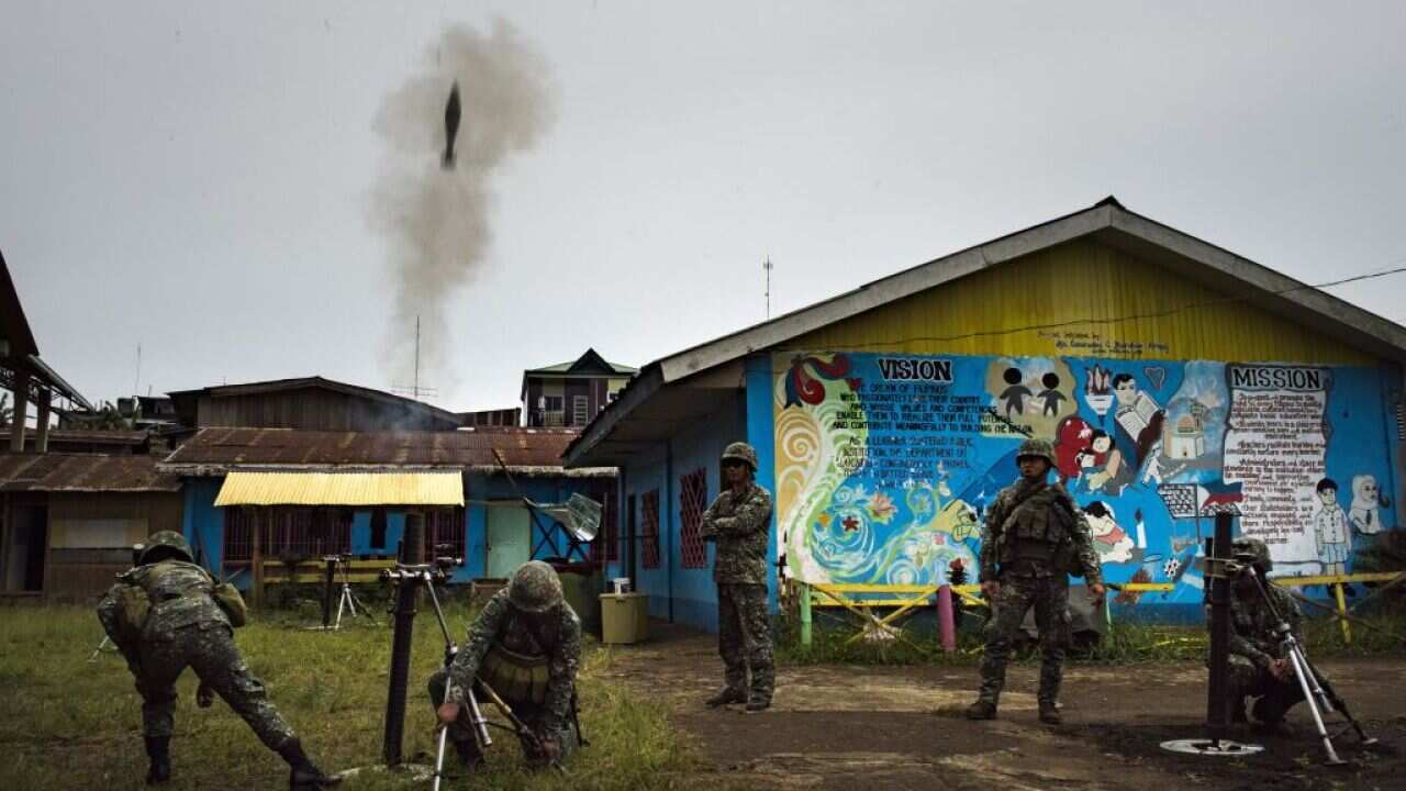 Philippine Marines soldiers firing mortar rounds towards enemy positions on July 22, 2017 in Marawi, southern Philippines.