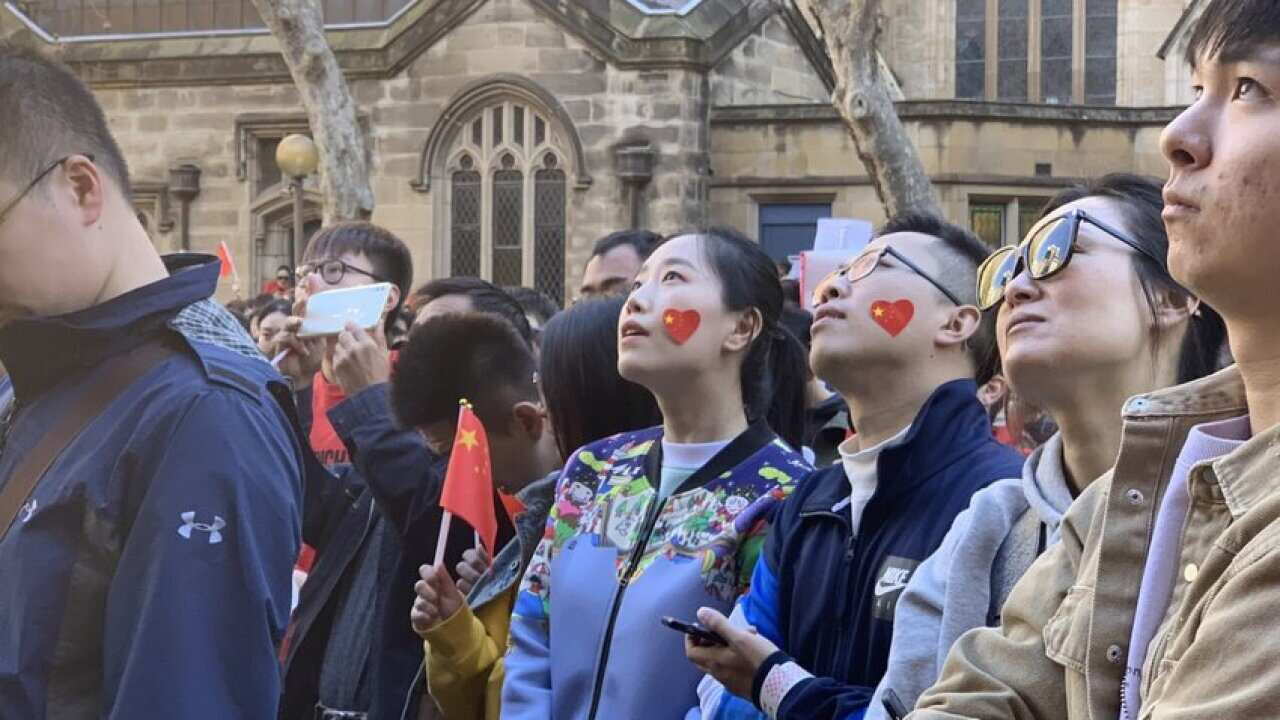 People attend a pro-China march in Sydney