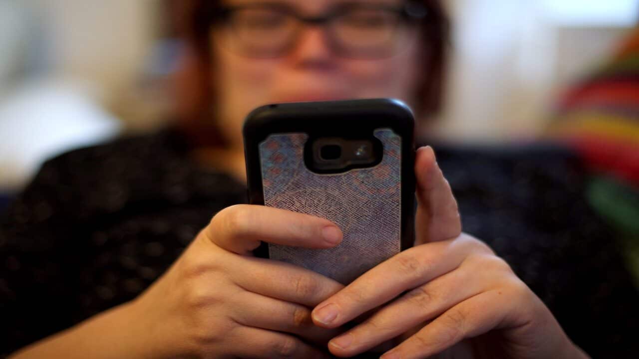 File photo of a woman using her smartphone.