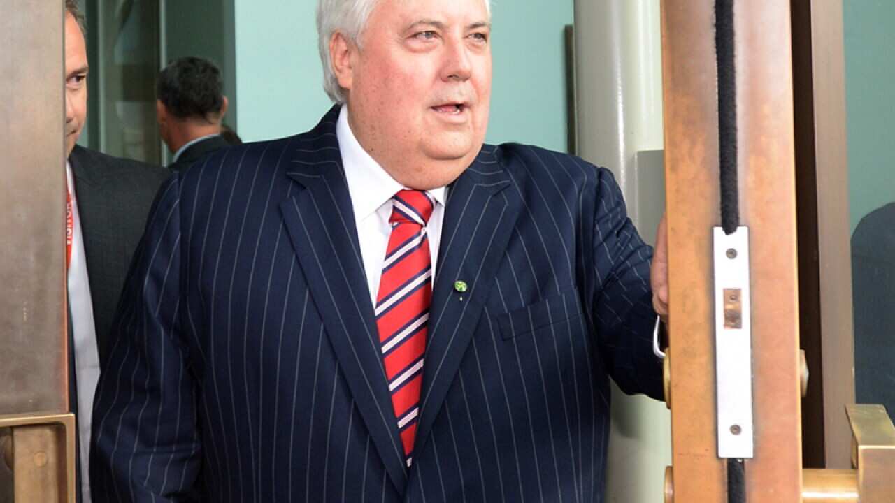 Clive Palmer opens a door in Canberra