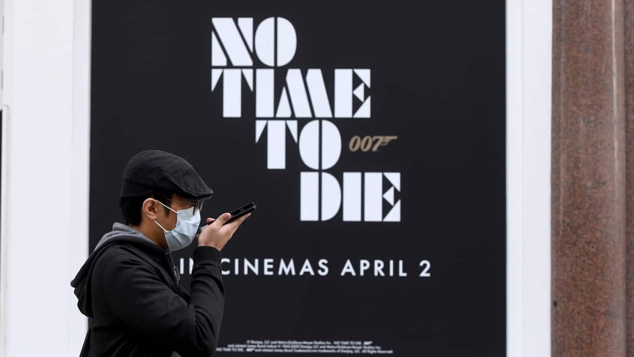 epaselect epa08286816 A man walks past a new James Bond movie advert 'No Time To Die' in London, Britain,