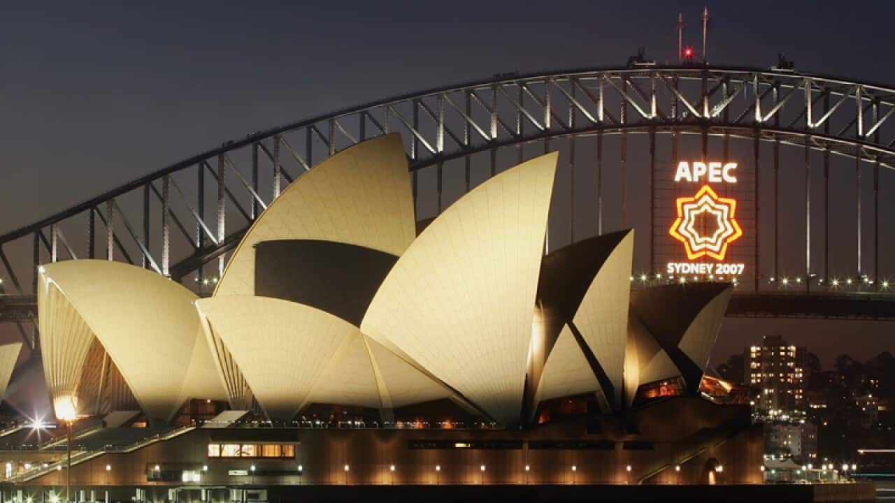 An APEC logo is light on the Sydney Harbour Bridge