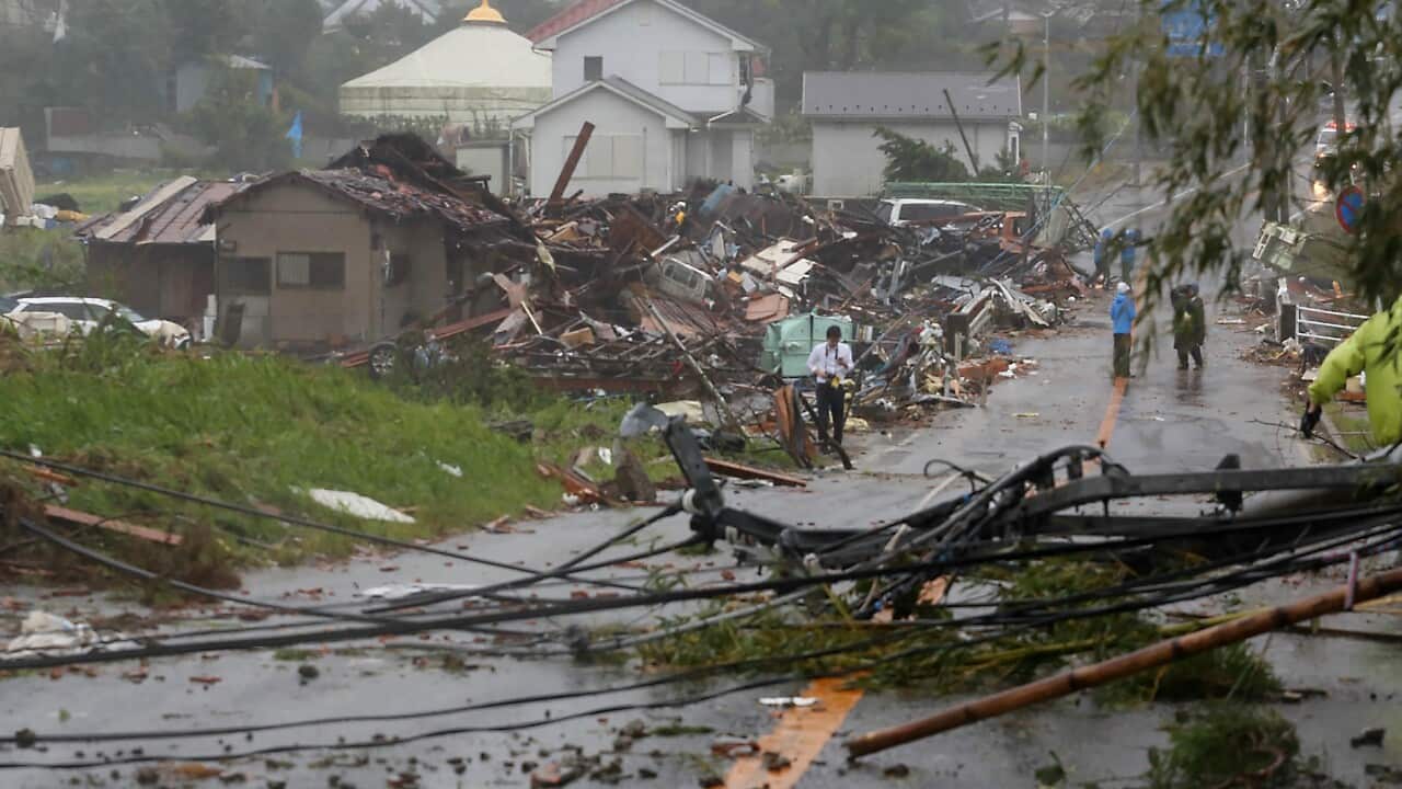 Residents check on homes damaged by strong winds brought by Typhoon Hagibis in Ichihara, Chiba.