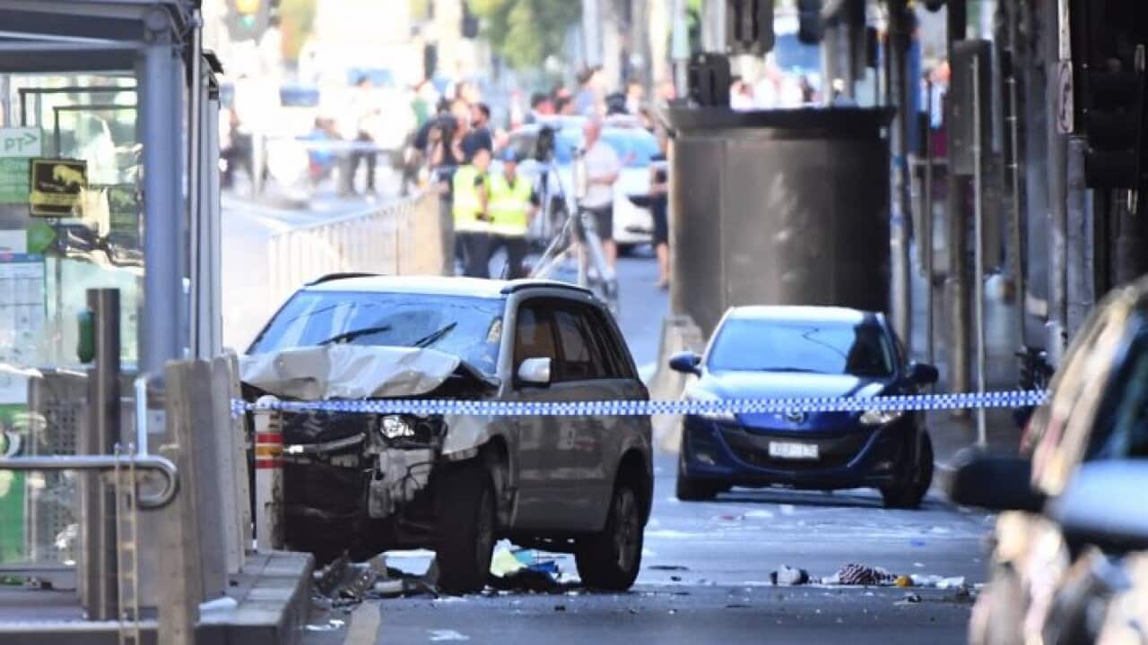 A damaged vehicle is seen at the scene of an incident on Flinders Street, in Melbourne, Thursday, December 21, 2017.