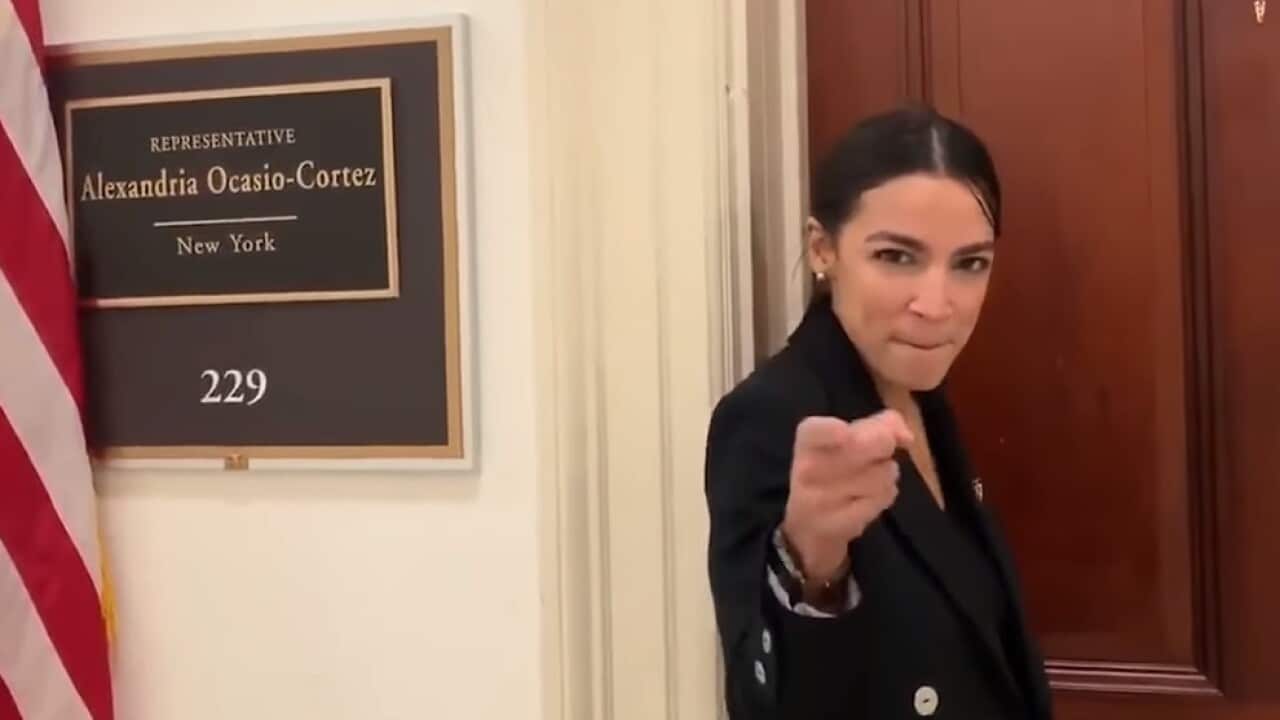 Alexandria Ocasio-Cortez dancing outside her new congressional office.