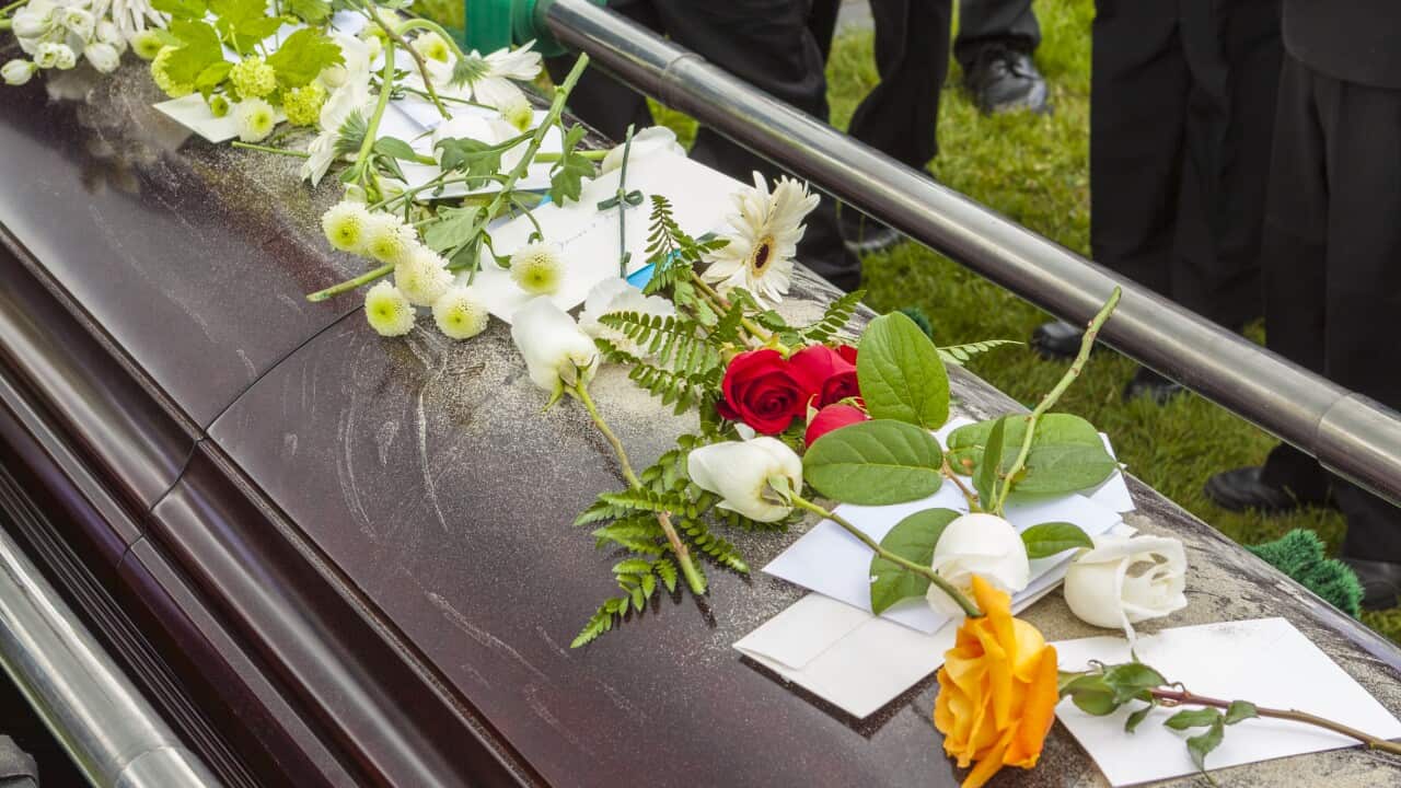 Flowers and cards on casket