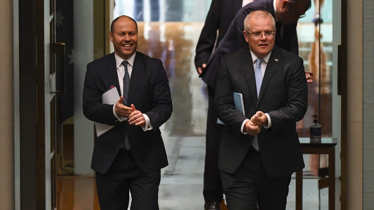 Prime Minister Scott Morrison (R) and Treasurer Josh Frydenberg (L) attend a parliamentary sitting.