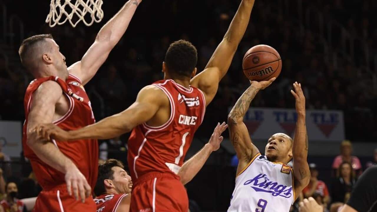 Jerome Randle of the Kings shoots despite pressure from opponents.