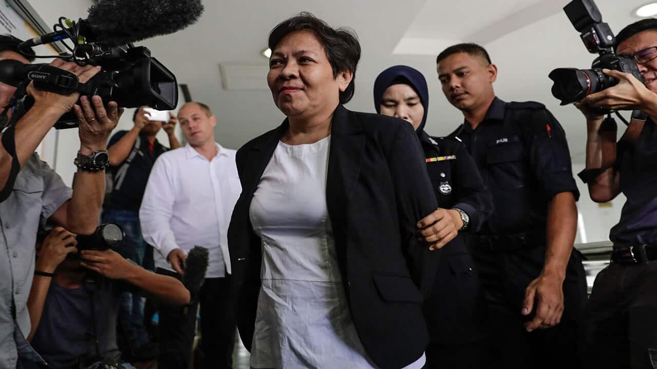 Australian Maria Elvira Pinto Exposto (C), escorted by Royal Malaysian Police (RMP) officers.