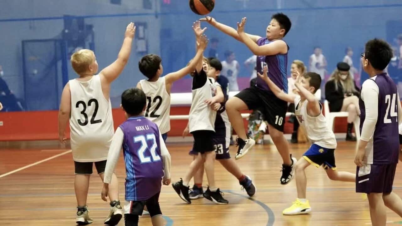 Basketball coach Mr. Yan and his team.jpeg