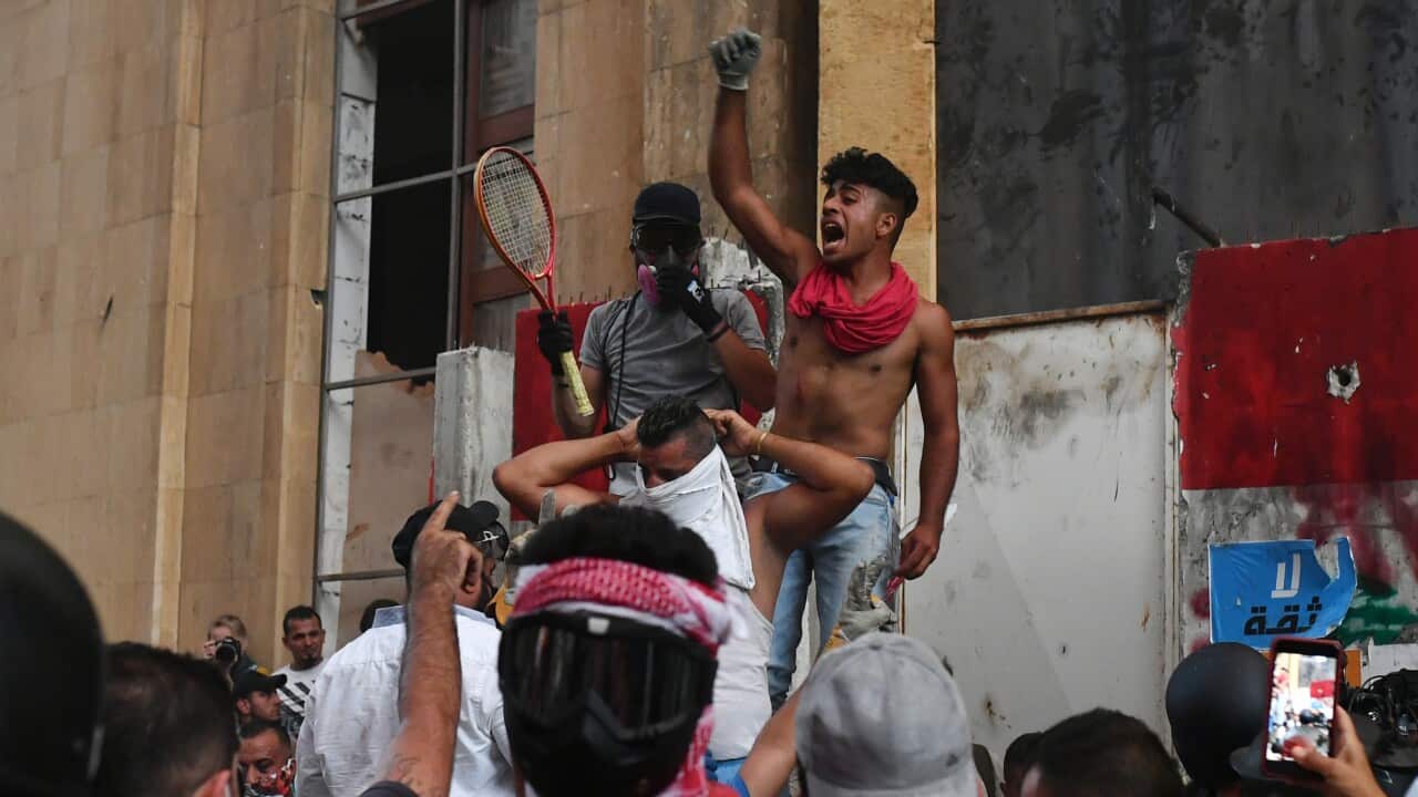 People hold a protest outside the offices of Lebanon's Parliament, 10 August 2020.