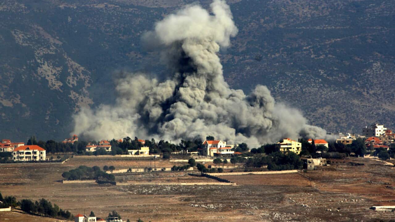 Smoke rises from a site where a rocket has hit.